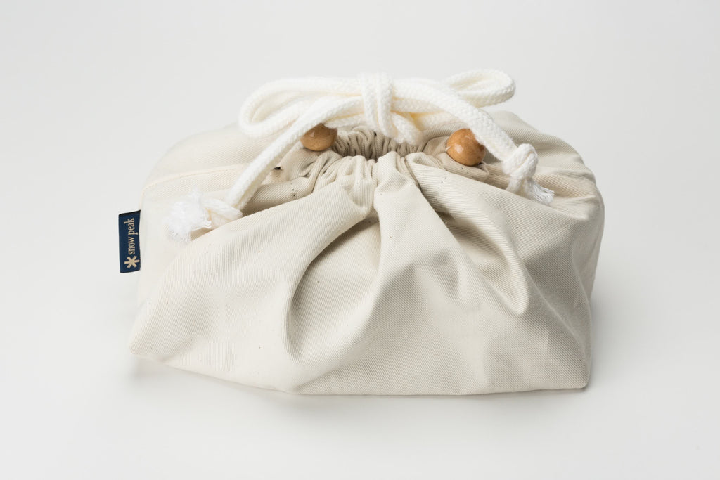 This is the the Magemono Bento Box wrapped in a bag. It is a light and durable lunch box made of wood.